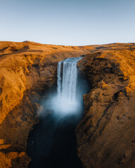 Fototapeta na wymiar Iceland. Aerial view on the Skogafoss waterfall. Landscape in the Iceland from air. Famous place in Iceland. Landscape from drone. Travel concept. Sunset and sunrise. Soft light.