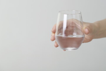 Close up of woman holding glass of water