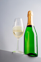 Champagne elegance: Glass and bottle against a grey background