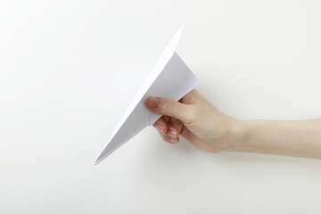 Close up of woman holding paper airplane