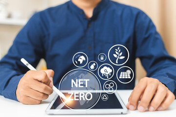 Businessman using tablet with Net zero icons. innovation warming 2050 alternative. Carbon offset In...