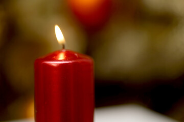 burning red candle on blur and bokeh background.