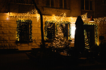 In the evening's historic cityscape, the beautiful architecture shines with holiday lights. A...