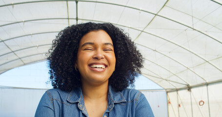 Close up portrait of smiling woman farmer standing in greenhouse tent