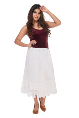 Young Indian girl wearing red velvet top and white crochet skirt with elegant pose and expression