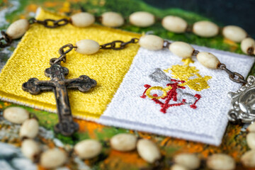 Vatican flag and rosary on world map, Concept, religion and Christianity, church influence in the...