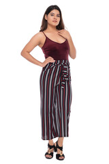 Young Indian girl wearing red velvet top and stripped pants with elegant pose and expression
