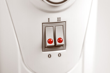 Turned on hot heating radiator with two switches and indicator red lights