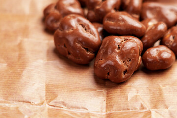 Glazed chocolate nut candies. Walnut dragee