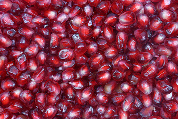 Full background texture of peeled pomegranate seeds.