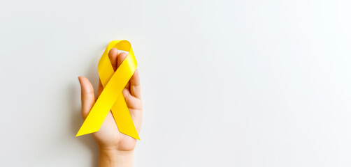 yellow Ribbon against white background for endometriosis awareness campaign, suicide prevention , a Childhood cancer. - obrazy, fototapety, plakaty
