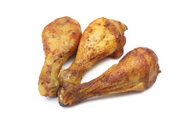 Three roasted and marinated chicken drumstick thigh legs isolated on white background
