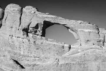 Classic monochrome black and white image of a natural sandstone arch formation in Arches National...