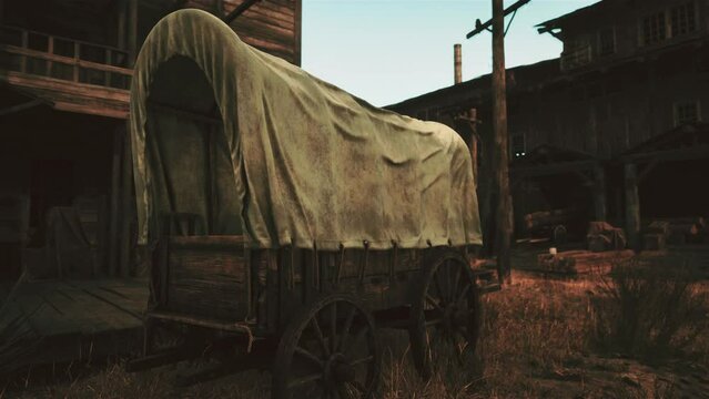 An old covered wagon sitting in the middle of a field
