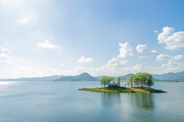 Beautiful scenic of water dam with the trees island at dam in Thailand.