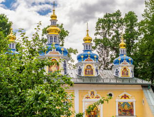 Colorful domes of the Pechora Holy Dormition Pskovo-Pechersky Monastery. Pskov region religion,...