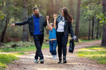 Cheerful beautiful family during an evening walk in the park