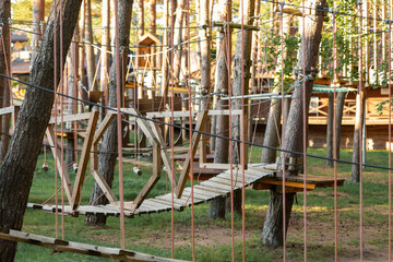 Fototapeta na wymiar An obstacle course for children and teenagers in an adventure park