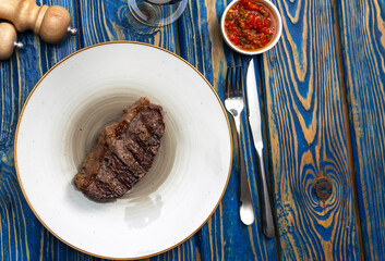 Sirloin steak  and cherry tomatoes on a plate with wine. View from above