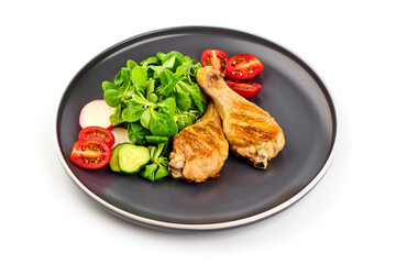 Fried chicken drumsticks served with salad, isolated on white background.