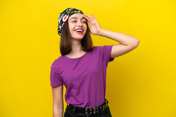 Young Ukrainian woman isolated on yellow background smiling a lot