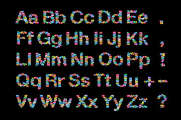 Top view of the English alphabet made of colorful audio cassettes with the English alphabet scattered on a black background. The concept of music theme gift cards or disc covers, designers resource
