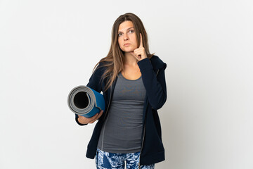 Fototapeta premium Slovak girl going to yoga classes isolated on white background thinking an idea