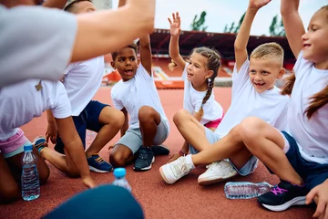 Foto op Plexiglas Happy kids having fun during sports training at stadium. © Drazen