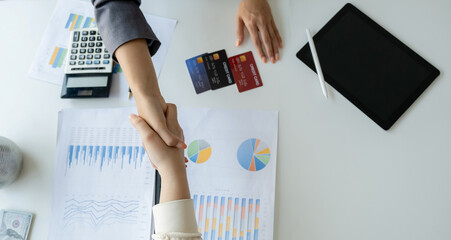 Hand shake after Employees present with mock up credit card payments to business customers. Ready...