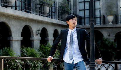 Young businessman financier investors stand with a luxurious black hotel building in the background