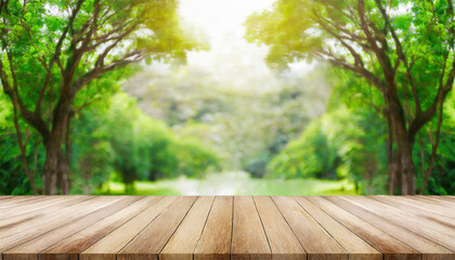 Empty wood table top over blur green forest background, product display montage