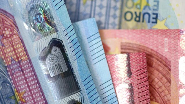 Euro banknotes moving on the blue paper background. 4K stop motion animation. Top view transition.