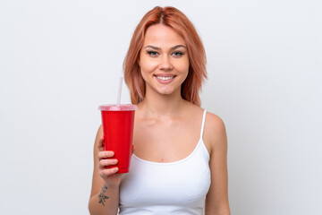 Young Russian woman holding soft drink isolated on white background smiling a lot