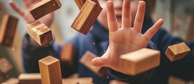 The child plays a game with falling wooden blocks.