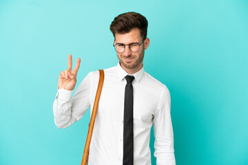 Business man over isolated background smiling and showing victory sign