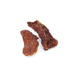 Two pieces of dried oily tomato isolated on white background 
