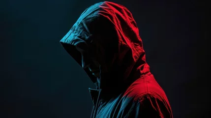 Foto op Plexiglas A hooded man with his face covered, set against a black background—illustrating the concepts of hacking and information protection © Matthew