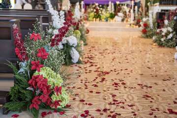 Fototapeta na wymiar isle and red rose petal of a church on a wedding day