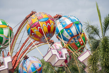 Flying balloon machines in amusement park
