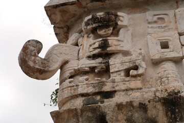 Typical mayan mask face on the edge of the facade of The Church, La Iglesia at Chichen Itza, close...