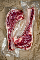 Obraz premium fresh beef in vacuum packaging on a background of kraft paper