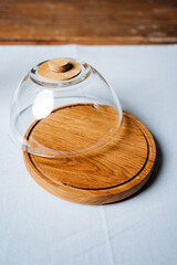 Handmade round shape oiler, glass lid, wooden backing, kitchen utensils.
