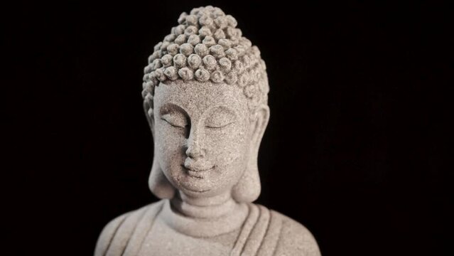 Decorative Buddha statue sculpture meditating with dark background