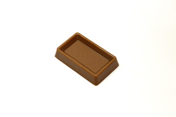 Bite size,milk chocolate square shaped treat isolated on white background