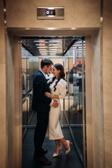 The image is of a man and woman kissing in an elevator 5014.