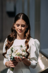 A woman holding a bouquet of flowers 5055.