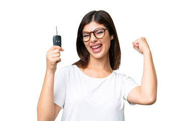 Young Russian woman holding car keys over isolated chroma key background celebrating a victory