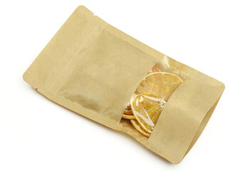 Dry orange slices in paper bag isolated on white background. Healthy vegan fruit food