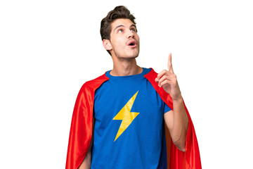 Super Hero caucasian man over isolated background pointing up and surprised © luismolinero