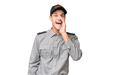 Young security man over isolated background shouting with mouth wide open